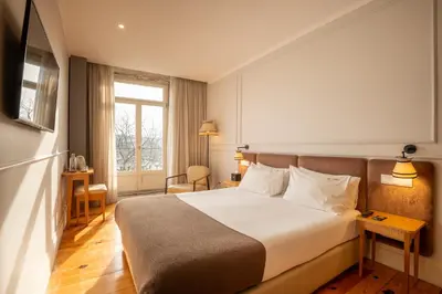 a hotel room with a bed and a window at Memoria Porto FLH Hotels in Porto
