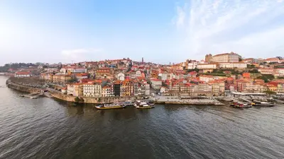 an aerial view of a city with boats in the water at Memoria Porto FLH Hotels in Porto
