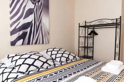 a bedroom with a bed with black and white sheets at Ninho @ Francos in Porto