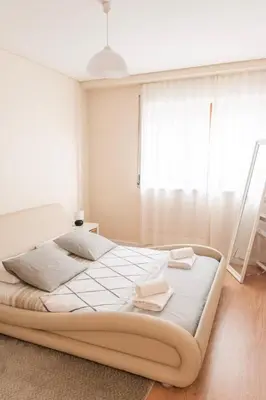 a bedroom with a bed with two towels on it at Ninho @ Francos in Porto