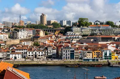 a city with buildings and a body of water at HM - Infante Riverside Apartment N in Porto