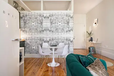 a living room with a table and white chairs at Historic apartment at Cardosas with balcony in Porto