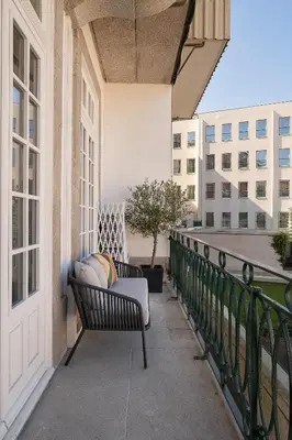a balcony with a bench and a view of a building at Historic apartment at Cardosas with balcony in Porto