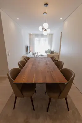 a dining room with a wooden table and chairs at ORM Antero Apartment in Porto