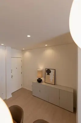 a living room with a table and a lamp on it at ORM Antero Apartment in Porto