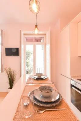 a kitchen with a table with plates on it at Sweet Home Firmeza in Porto