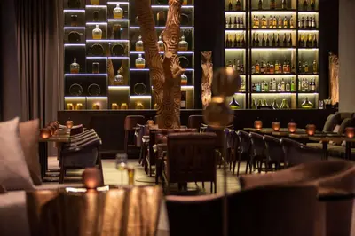 a restaurant with tables and chairs and a bar at Hilton Porto Gaia in Vila Nova de Gaia