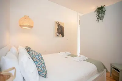 a bedroom with a bed with a lamp on it at Liiiving in Porto - Downtown Balcony Studio in Porto