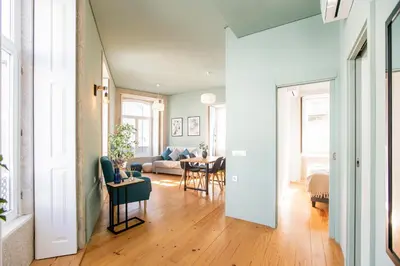 a living room with a couch and a table at Mouzinho Darling 1BR w/ AC in City Center by LovelyStay in Porto