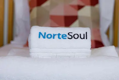 a pile of towels with the wordsnetride south on them at NorteSoul Porto à Vista in Vila Nova de Gaia