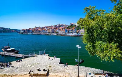 a view of a river with a dock and buildings at NorteSoul Porto à Vista in Vila Nova de Gaia