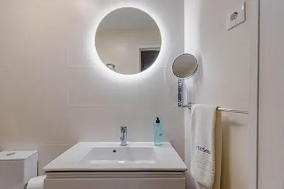 a white bathroom with a sink and a mirror at NorteSoul Porto à Vista in Vila Nova de Gaia