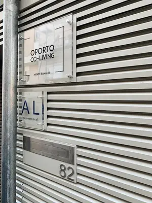 a sign on the side of a building at Oporto CoLiving Monte Ramalde in Porto