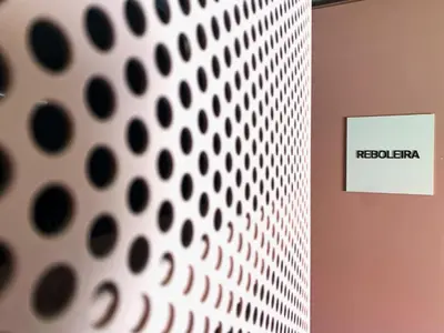 a white sign on a wall with a patterned wall at Oporto CoLiving Monte Ramalde in Porto