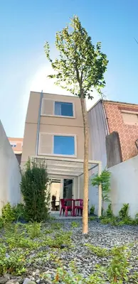 a house with a tree in front of it at Oporto CoLiving Monte Ramalde in Porto