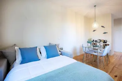 a bedroom with a bed and a table with chairs at North Side in Porto
