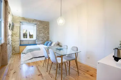 a bedroom with a bed and a table and chairs at North Side in Porto