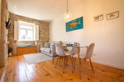 a living room with a table and chairs and a couch at North Side in Porto