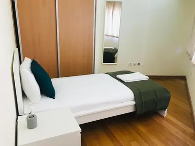 a bedroom with a white bed and a mirror at Congregados Apartment in Porto