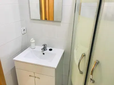 a bathroom with a sink and a shower at Congregados Apartment in Porto