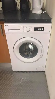 a white washing machine with a black counter top at Congregados Apartment in Porto
