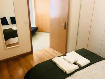a bedroom with a bed with two towels on it at Congregados Apartment in Porto