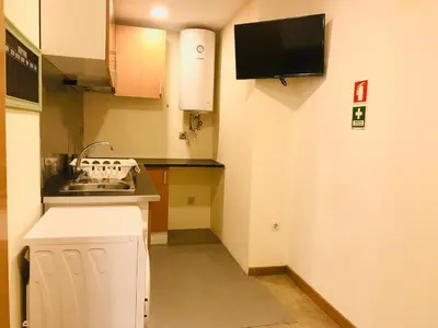 a small kitchen with a sink and a microwave at Congregados Apartment in Porto