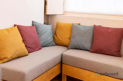 a couch with different colored pillows on it at Stylish Triplex next to Ribeira in Porto