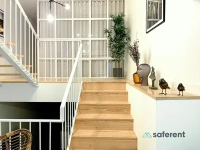 a staircase in a home with white walls and wood floors at Stylish Triplex next to Ribeira in Porto