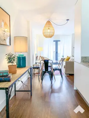 a living room with a table and chairs at The Wondrous Central Apartment in Porto
