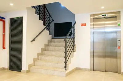 a staircase with a television and a elevator at The Beautiful Ones Studio in Porto