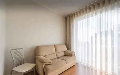 a living room with a couch and a chair and a window at Silver Duque in Porto