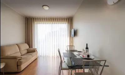a living room with a table and a couch at Silver Duque in Porto