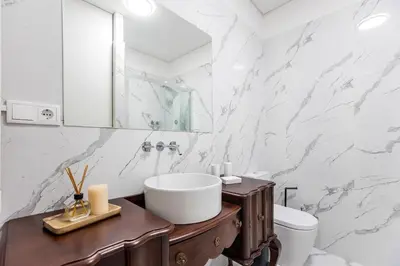 a bathroom with a sink and a toilet at Mouzinho Darling Studio w/ AC in City Center by LovelyStay in Porto