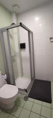 a bathroom with a shower and a toilet at Get Cozy in Porto