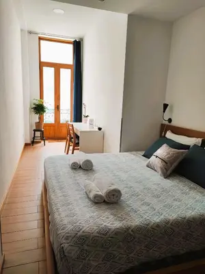 a bedroom with a bed with two towels on it at Get Cozy in Porto