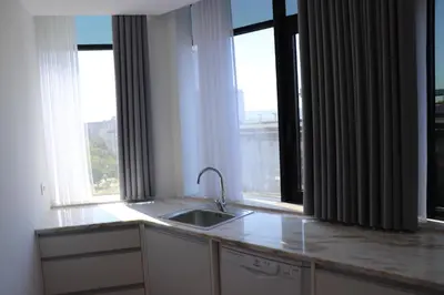 a kitchen with a sink and two large windows at 3 Bedrooms Central Apartment with garage by Great&Cosy in Porto