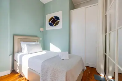 a bedroom with a soccer ball on the wall at CLUBE Charming Apartments - Ribeira in Porto