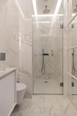 a white bathroom with a shower and a toilet at CLUBE Charming Apartments - Ribeira in Porto