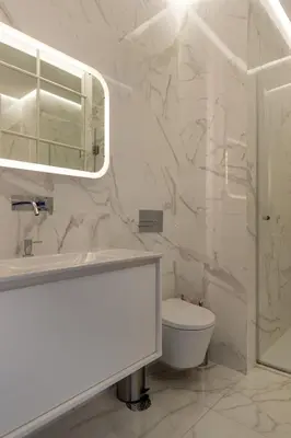 a bathroom with a sink and a toilet and a mirror at CLUBE Charming Apartments - Ribeira in Porto