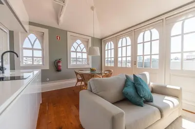 a living room with a couch and a table at CLUBE Charming Apartments - Ribeira in Porto