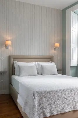 a white bathroom with a sink and a shower at CLUBE Charming Apartments - Ribeira in Porto