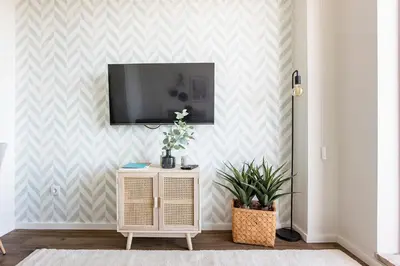 a living room with a tv on a wall at Elegant Studio w/ AC & Balcony by LovelyStay in Porto