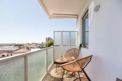 a balcony with two chairs and a table at Elegant Studio w/ AC & Balcony by LovelyStay in Porto