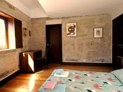 a bedroom with a bed and a table and a window at Framer's House - Authentic Downtown in Porto