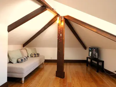 a living room with a couch in the attic at Framer's House - Authentic Downtown in Porto