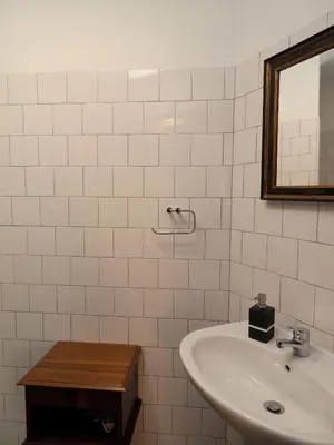 a white bathroom with a sink and a mirror at Framer's House - Authentic Downtown in Porto