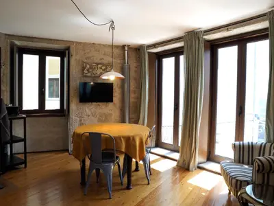 a dining room with a table with chairs and windows at Framer's House - Authentic Downtown in Porto