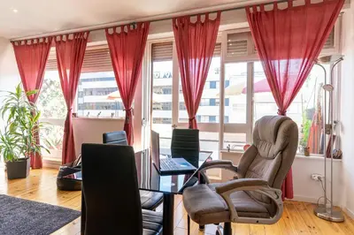 an office with red curtains and a table and chairs at Sunny Oporto, Trindade Balcony in Porto