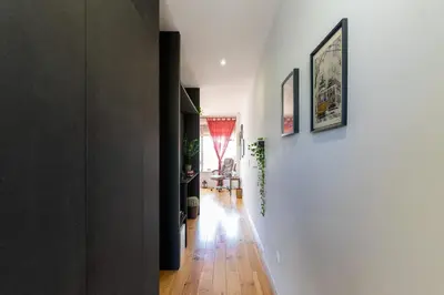 a hallway of a home with white walls and wooden floors at Sunny Oporto, Trindade Balcony in Porto
